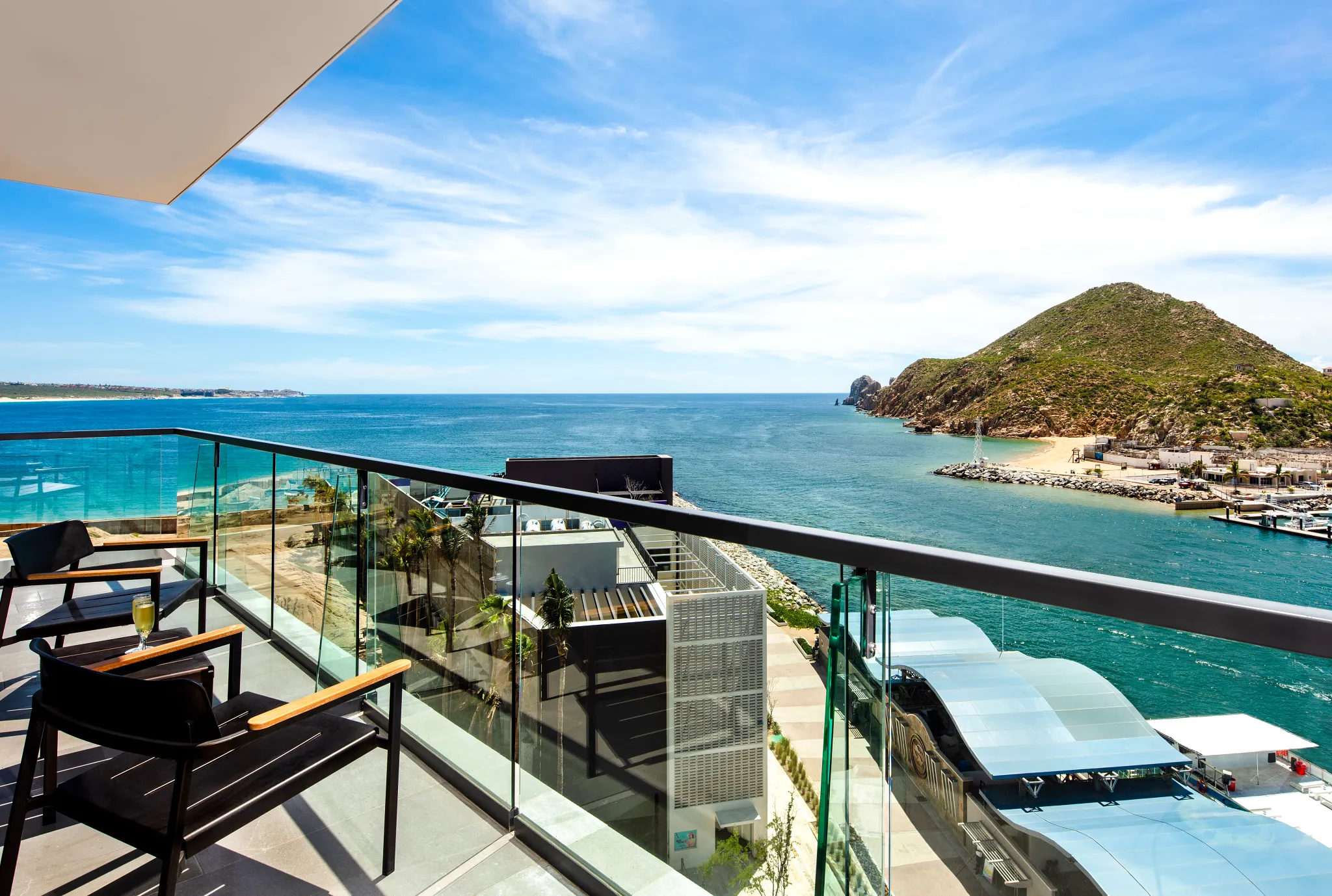 Daytime oceanfront balcony with panoramic views from the Xhale Club Master One Bedroom Suite at Breathless Cabo San Lucas.