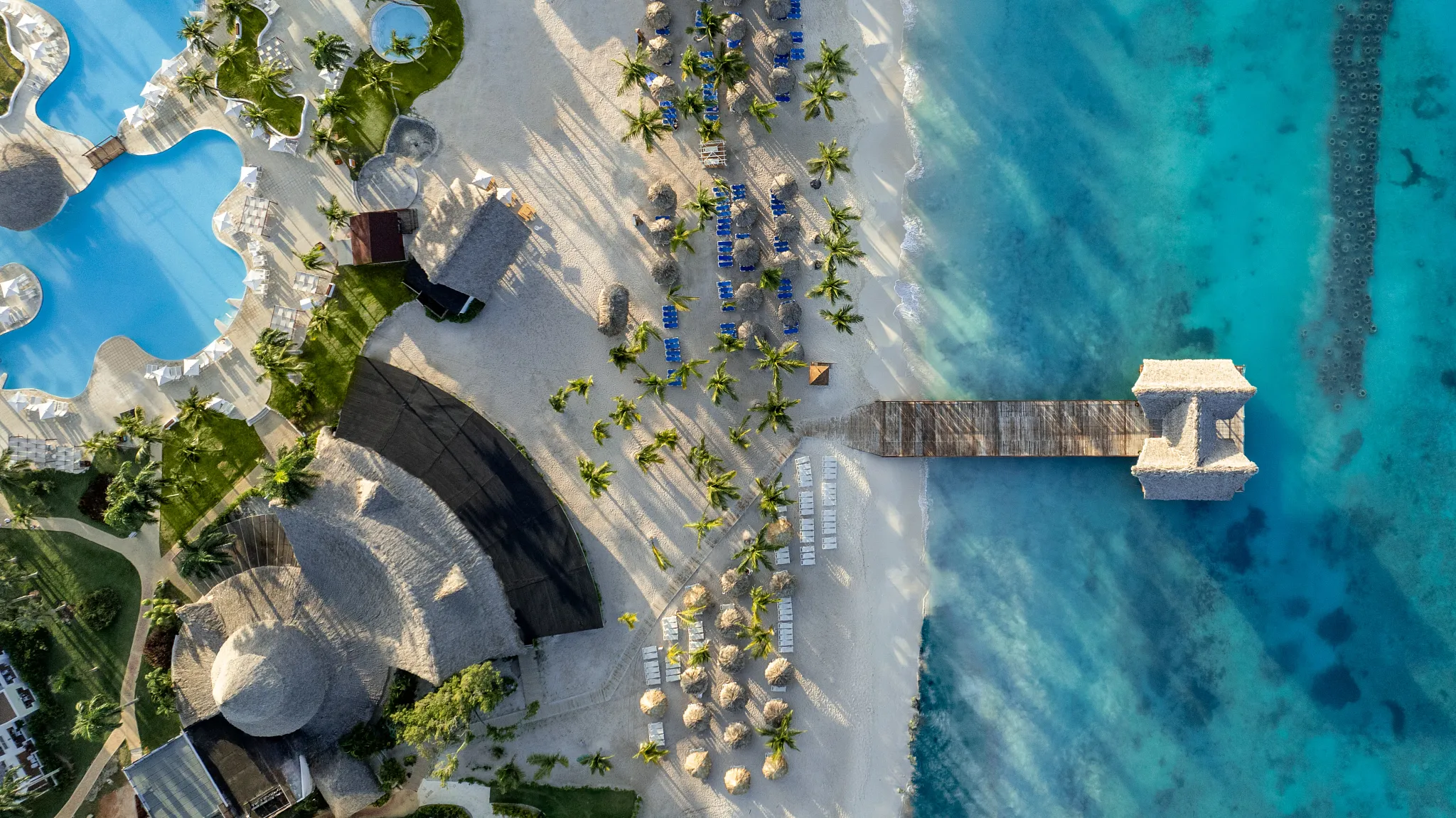 Aerial view of beach, pier, and turquoise waters at Sunscape Dominicus La Romana in the Dominican Republic.
