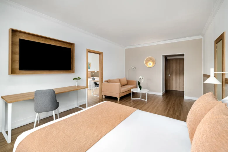 Deluxe Family Suite with bed, sofa seating area, and modern décor at Sunscape Dominicus La Romana.