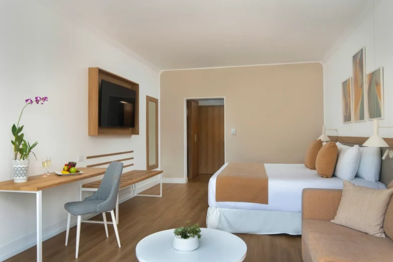 Deluxe Pool View king room with sofa seating area and balcony at Sunscape Dominicus La Romana.
