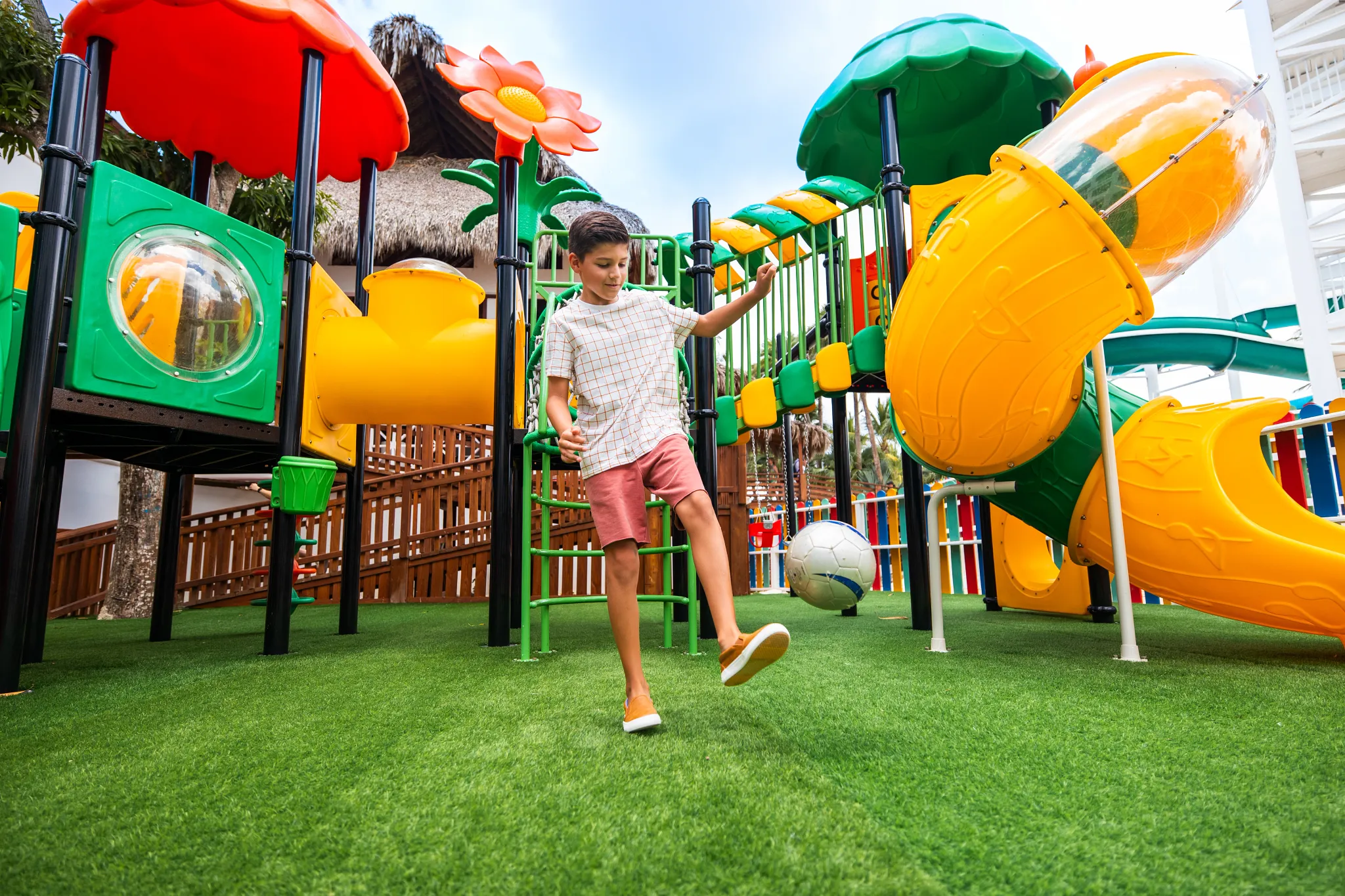 Child playing on a colorful outdoor playground at Sunscape Dominicus La Romana.