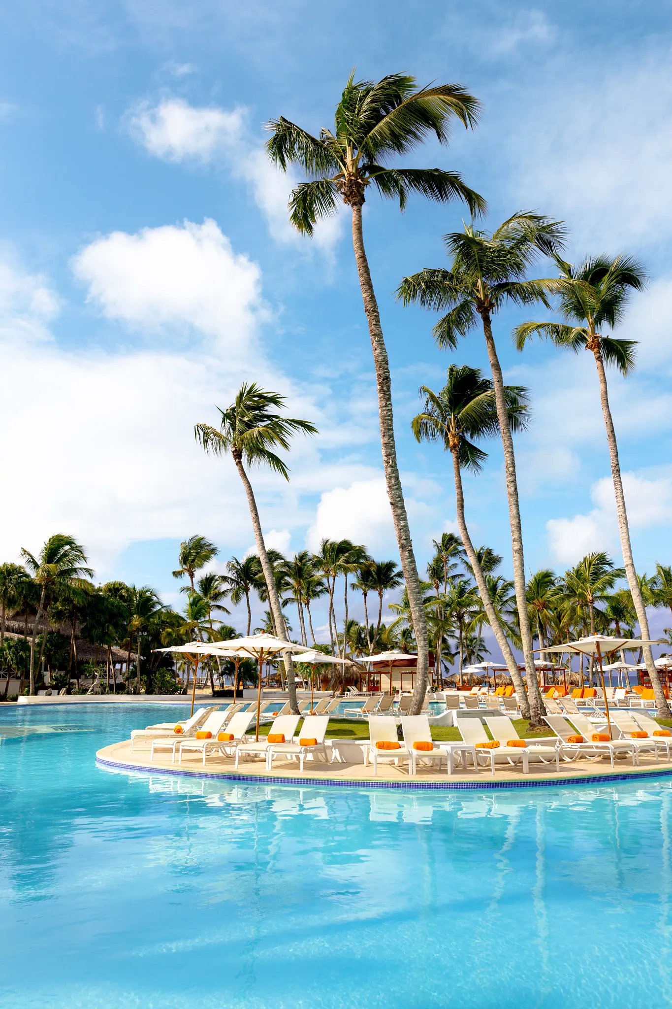 Tropical main pool with palm trees and loungers at Sunscape Dominicus La Romana, offering a relaxing family-friendly Caribbean setting.