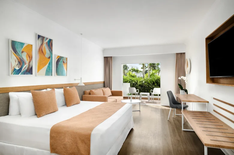 Sun Club Superior Tropical View king room with sofa and private balcony at Sunscape Dominicus La Romana.